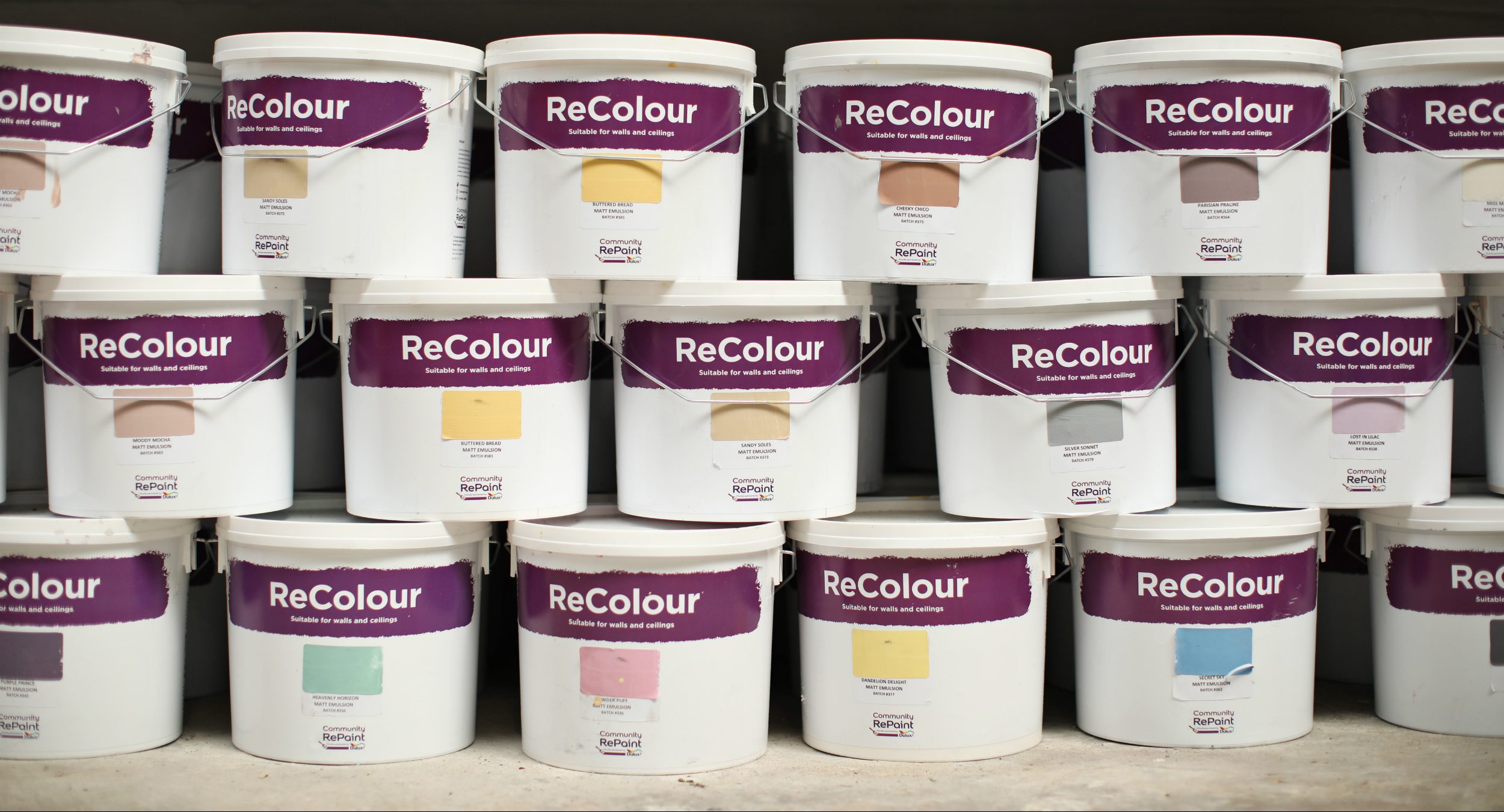A photo of a selection of our affordable, low-cost and environmentally friendly ReColour emulsion paint in a range of colours for sale at Emmaus Bolton.