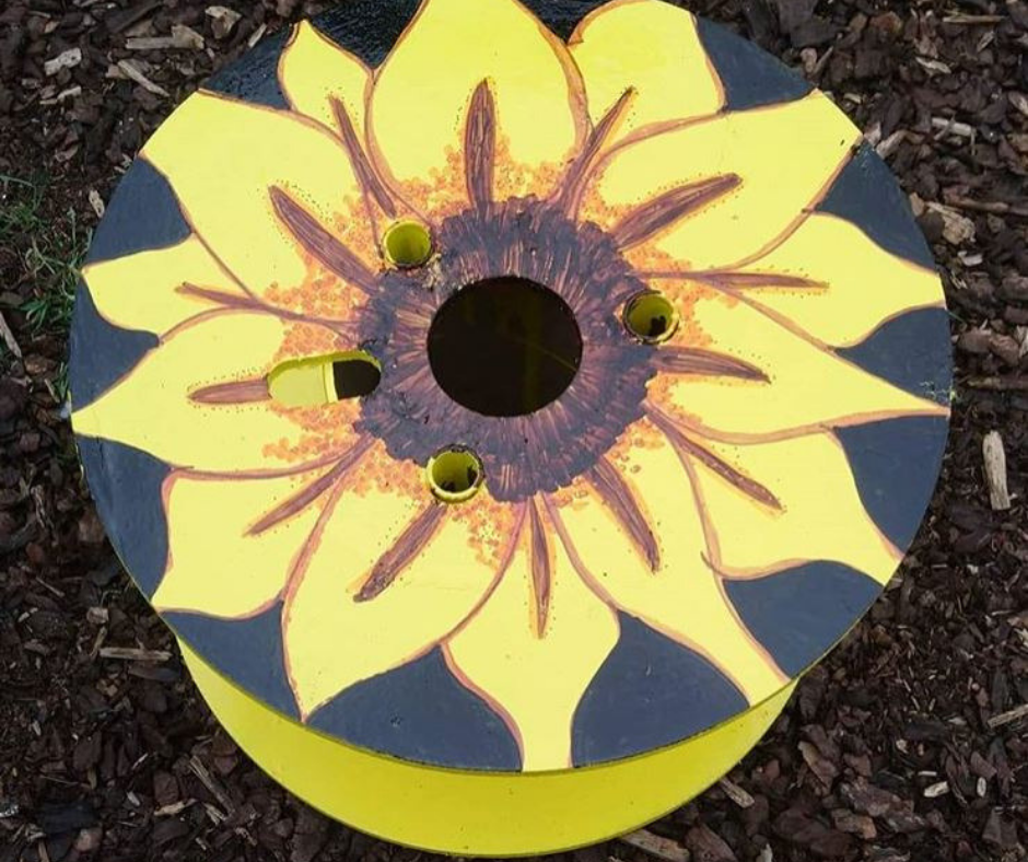 Upcycled cable reel that has been turned into a painted Fairy Garden, using cheap and recycled paint from Community RePaint Coventry.