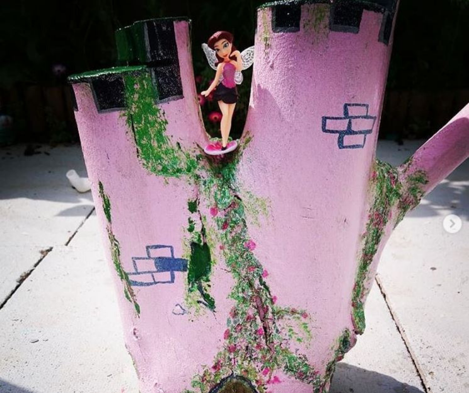 Upcycled cable reel that has been turned into a painted Fairy Garden, using cheap and recycled paint from Community RePaint Coventry.