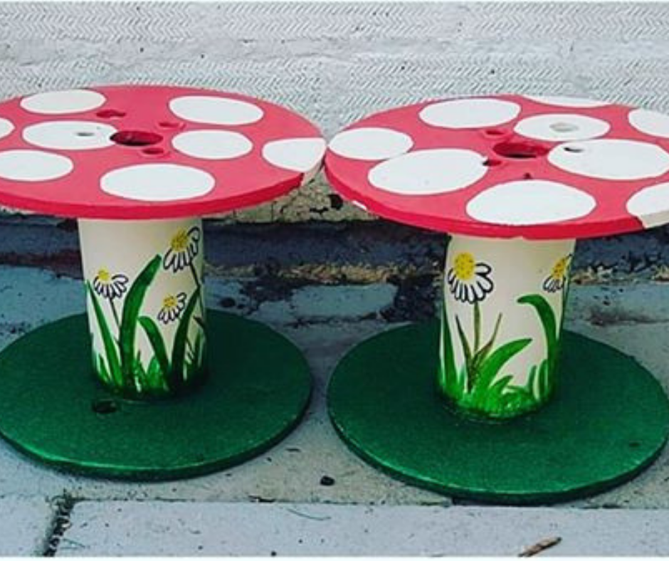 Upcycled cable reel that has been turned into a painted Fairy Garden, using cheap and recycled paint from Community RePaint Coventry.