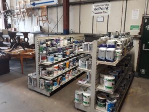 Paint display selling cheap and reusable paint at a Community RePaint Scheme.
