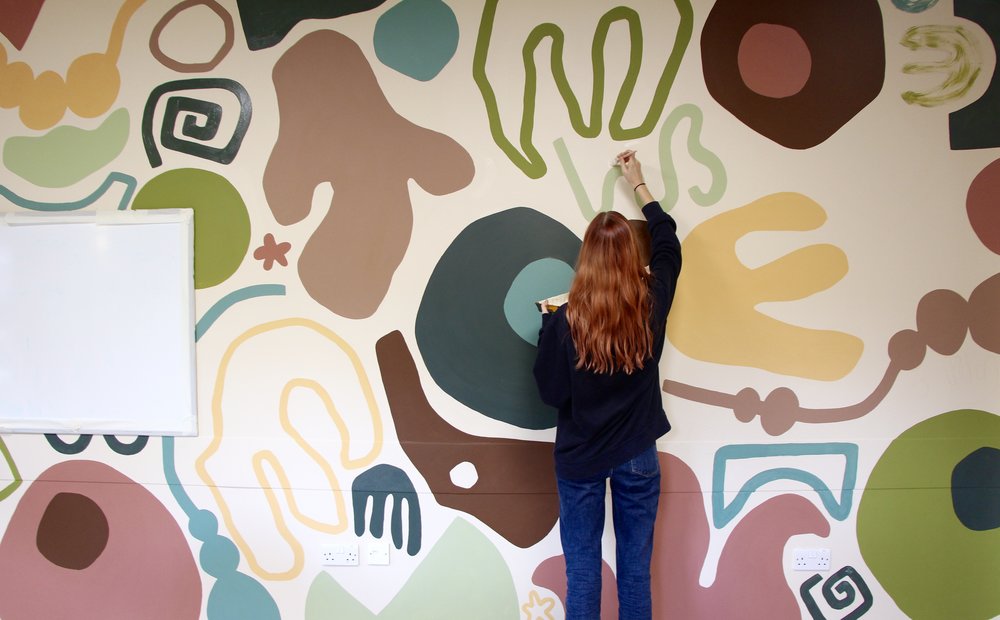 Painted community mural at Incredible Making Space, using cheap and recycled paint from Community RePaint East London.