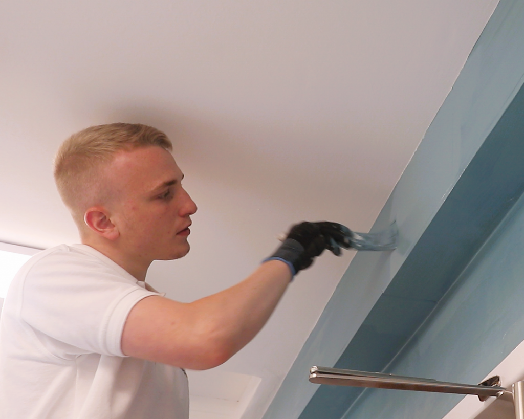 Student painting a community project